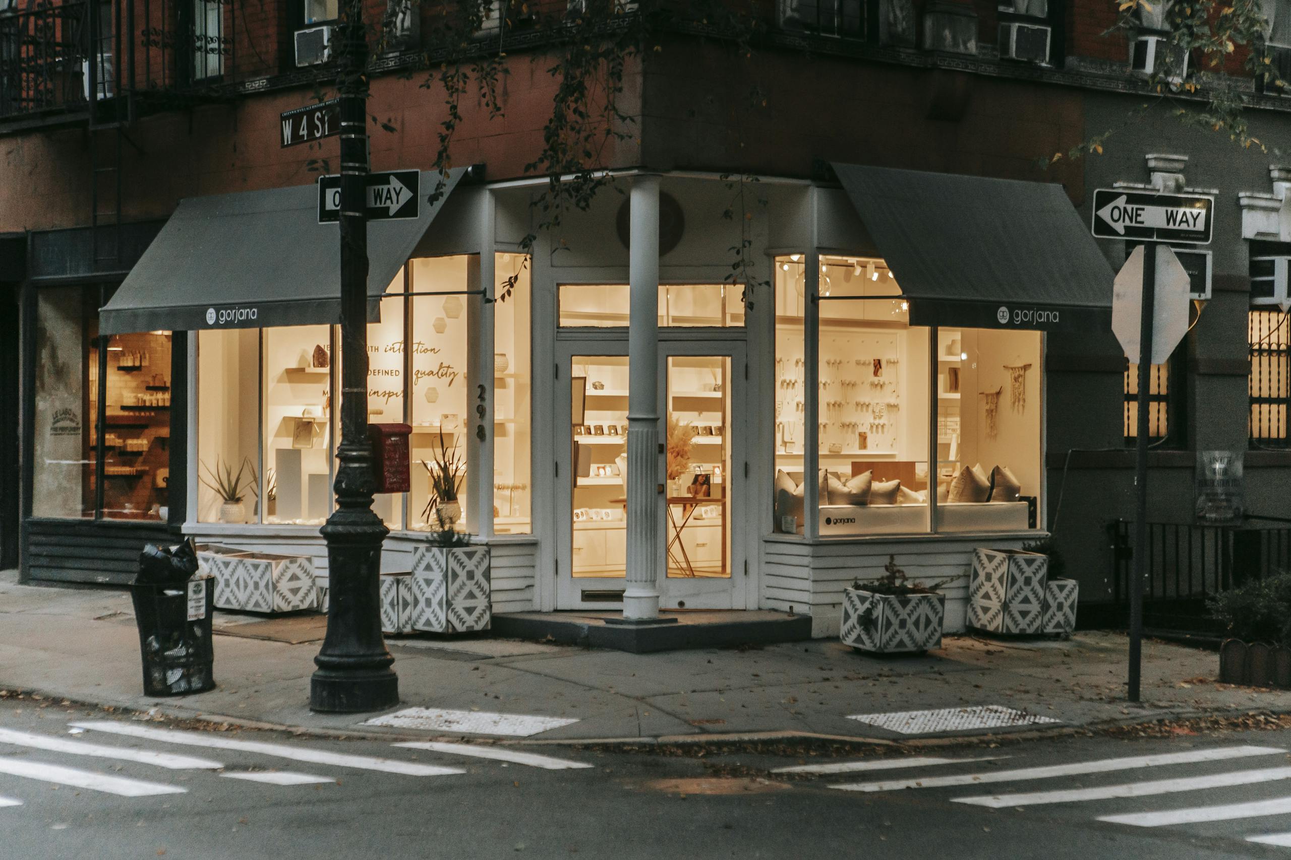 Cozy urban corner boutique with warm lighting and inviting design.